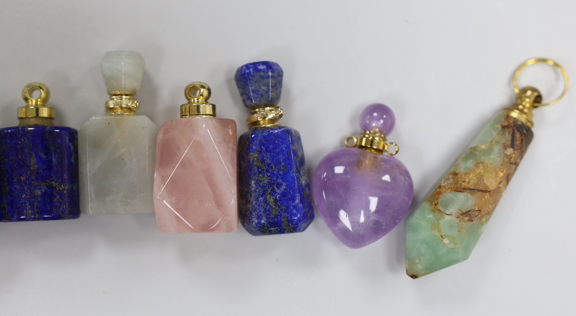 Eleven assorted gilt metal-mounted hardstone and semi-precious stones, small scent bottles, including Tiger's eye, rose quartz, lapis lazuli and amethyst.